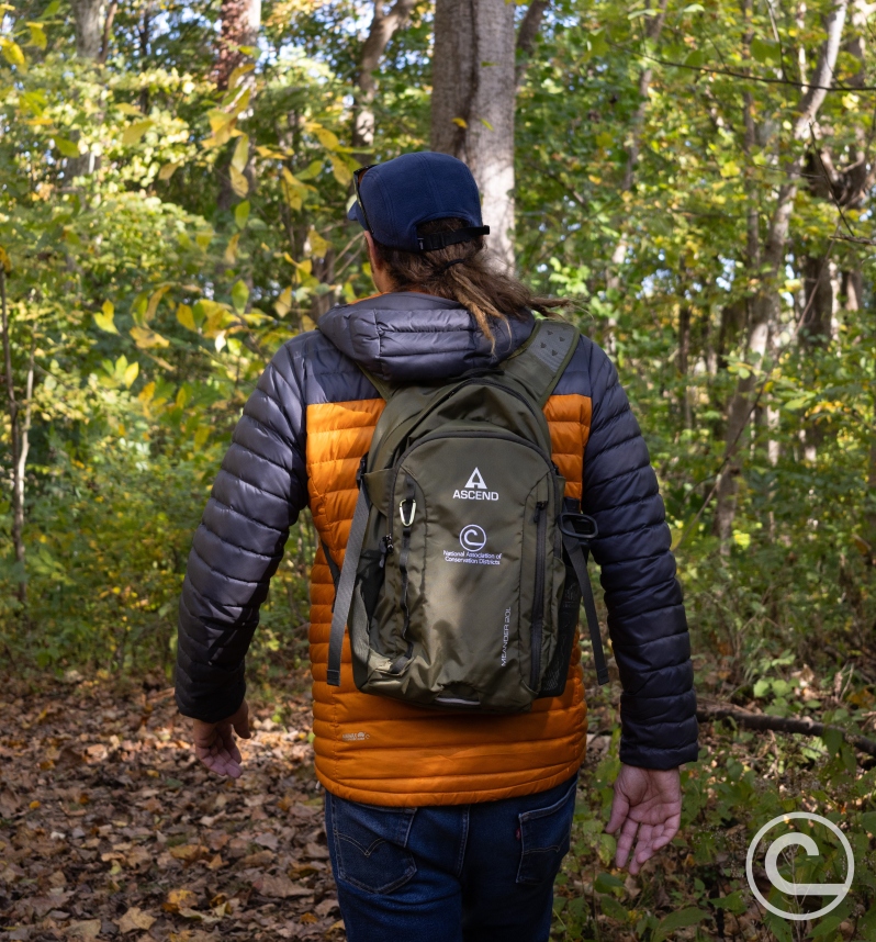 Product Description: CONTACT STEWARDSHIP@NACDNET.ORG for alternative products. </br></br>Click "More Images" above and expand window for additional photos!</br></br>We deeply value you as a customer and conservation partner.Once your order is placed, we will begin the customization process promptly. Please note that newly submitted logos may require additional time for embroidery or engraving setup, as well as a quality check. If we already have your logo on file or you have ordered previously, your order will typically be processed and shipped within a week. All items will be shipped directly from Bass Pro/Cabela's.</br></br>We are committed to ensuring your order is accurate and meets your expectations. To help us achieve this, please provide all necessary details such as sizes, colors, and other specifications. While we strive to keep all Marketplace items in stock, if availability is limited, our team will work to resolve any issues and ensure your satisfaction.</br></br>Custom Logo?Email it to us atstewardship@nacdnet.org</br></br>A great pack for weekend hikes, our Ascend® Meander 20L Daypack makes a great weekend pack for backpacking. Built to handle a 3L (100 oz.) hydration system (not included), this performance backpack offers 1,220 cu. in. of space for your outdoor gear. Built to handle the toughest environments, this durable pack is constructed of lightweight 400-denier nylon and features a large, easy-to-pack, main storage compartment with a mesh pocket; zippered front pocket; and dual stretch mesh side pockets. Side compression straps help you secure and stabilize gear. Outfitted with ventilation channels, the padded breathable mesh back panel works with the pack's ventilated and padded shoulder straps to let you haul big loads in comfort. A sternum strap between the shoulder straps and the removable web waist belt help you haul gear with optimal stability and comfort. Tough YKK® zippers. Front daisy chain reflective webbing and blinker light attachment for greater visibility. 18.7"H x 10"W x 7.5"D. Weight: 1 lb.</br></br>400-denier nylon construction</br>Large enough to handle a 3L hydration system (not included)</br>1,220 cu. in. of gear storage</br>Padded breathable mesh back panel with ventilation channels</br>Ventilated and padded shoulder straps with sternum strap</br>Zippered front pocket</br>Tough YKK zippers</br>Side compression straps</br> OUT OF STOCK - Ascend® Meander 20L Daypack